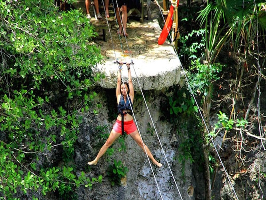 Annette White Ziplining over a Cenote in Mexico